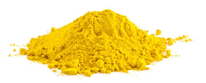 Bright yellow pigment splash against a soft blurred warm-toned background.