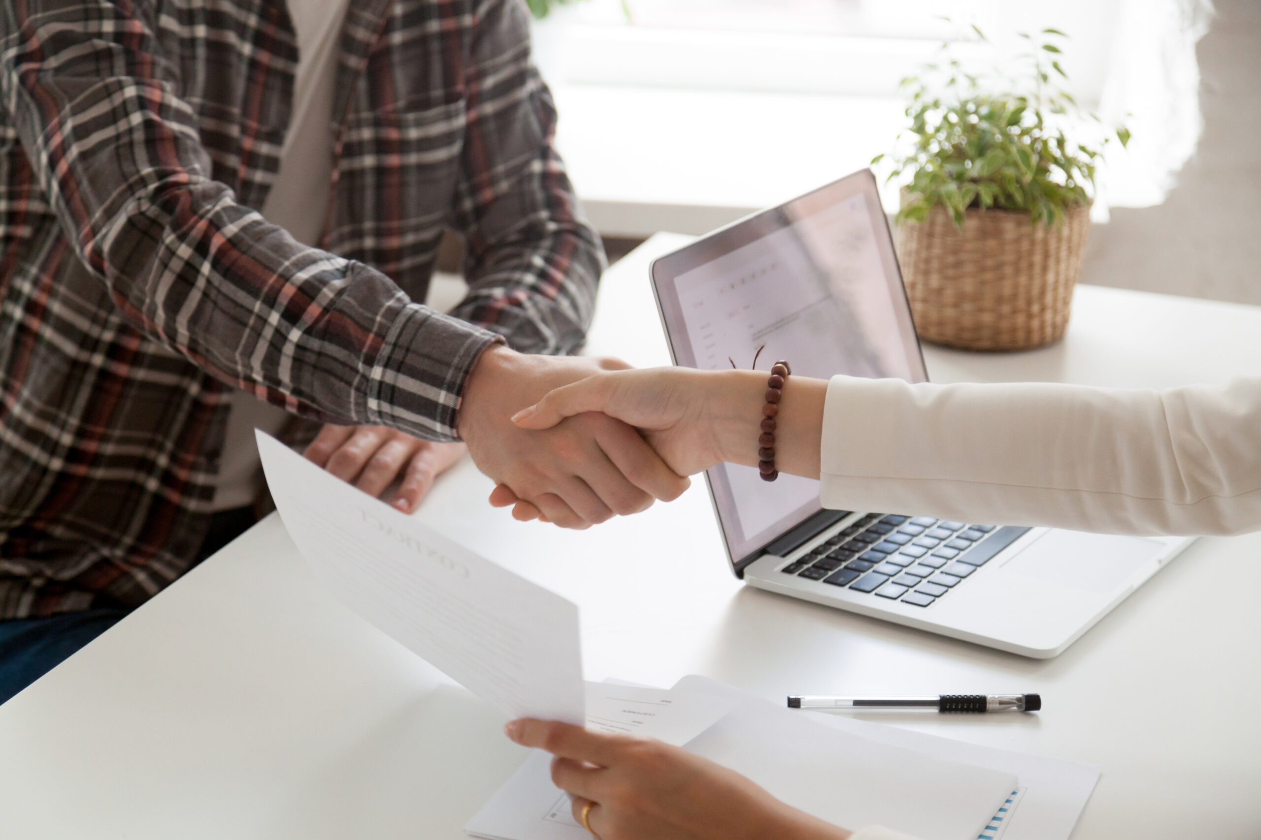 Close up of businesswoman shaking hand of male job candidate, greeting with successful interview, closing contract, female employer handshaking new employee welcoming in team. Employment concept