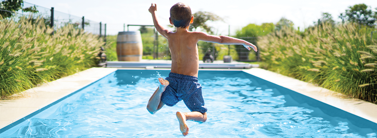 child jumping in pool