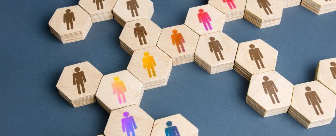 Abstract illustration of hexagonal tiles with business figure silhouettes and arrows representing organizational flow.
