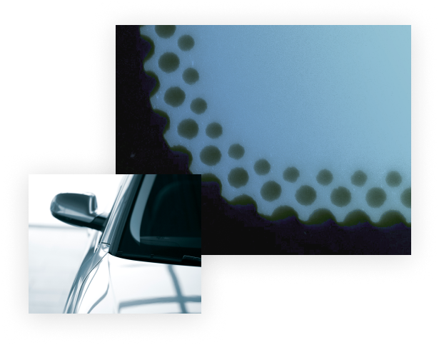 Automotive windshield at an angle, demonstrating pigment and coating applications on automotive glass components.