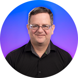 Professional headshot of a man wearing a dark shirt against a blue and purple gradient circular background.