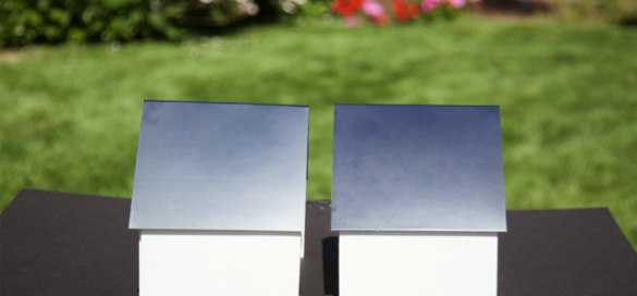 Two paint panels comparing Standard Dark Blue and YInMn Based Dark Blue on a dark surface with flowering garden background.