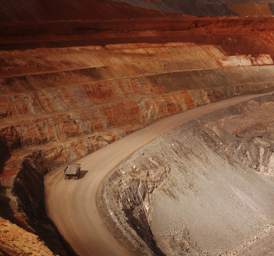 Aerial view of a mining operation in an arid landscape, illustrating resource extraction and environmental stewardship.